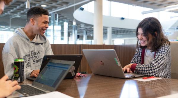 2 students on laptops