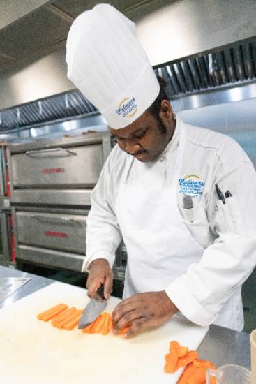 Chef chopping carrots