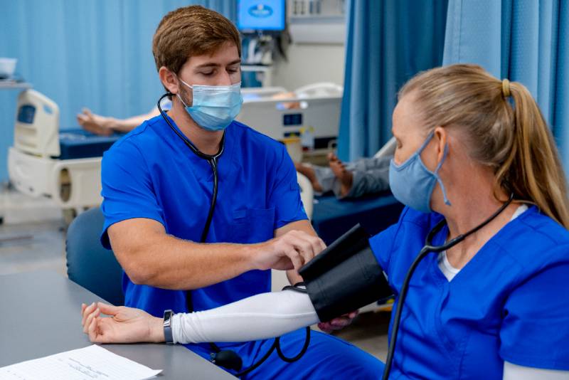 Student taking blood pressure