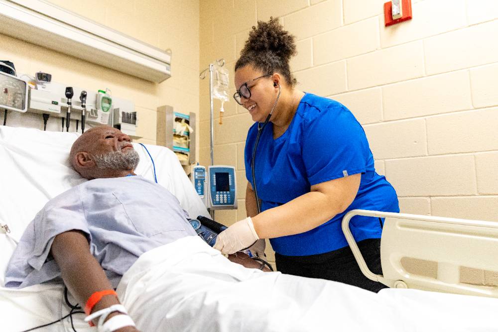 Nurse checking patient's blood pressure