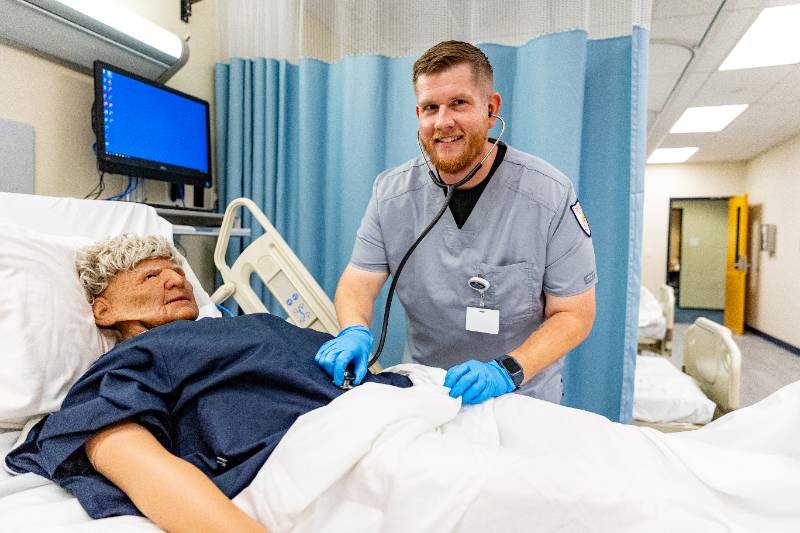 Male nurse listening to patience's chest