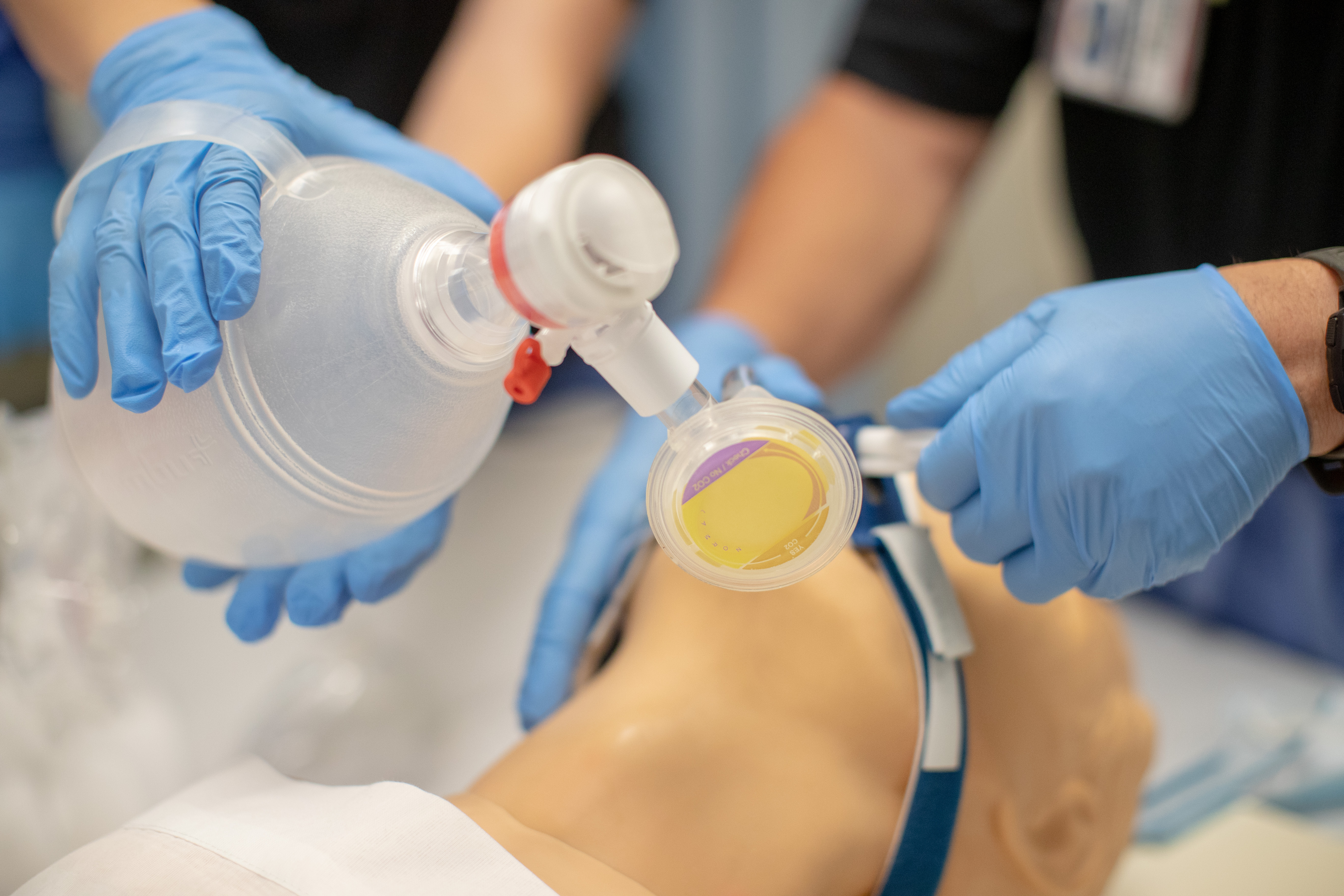 Student giving CPR in a hospital bed