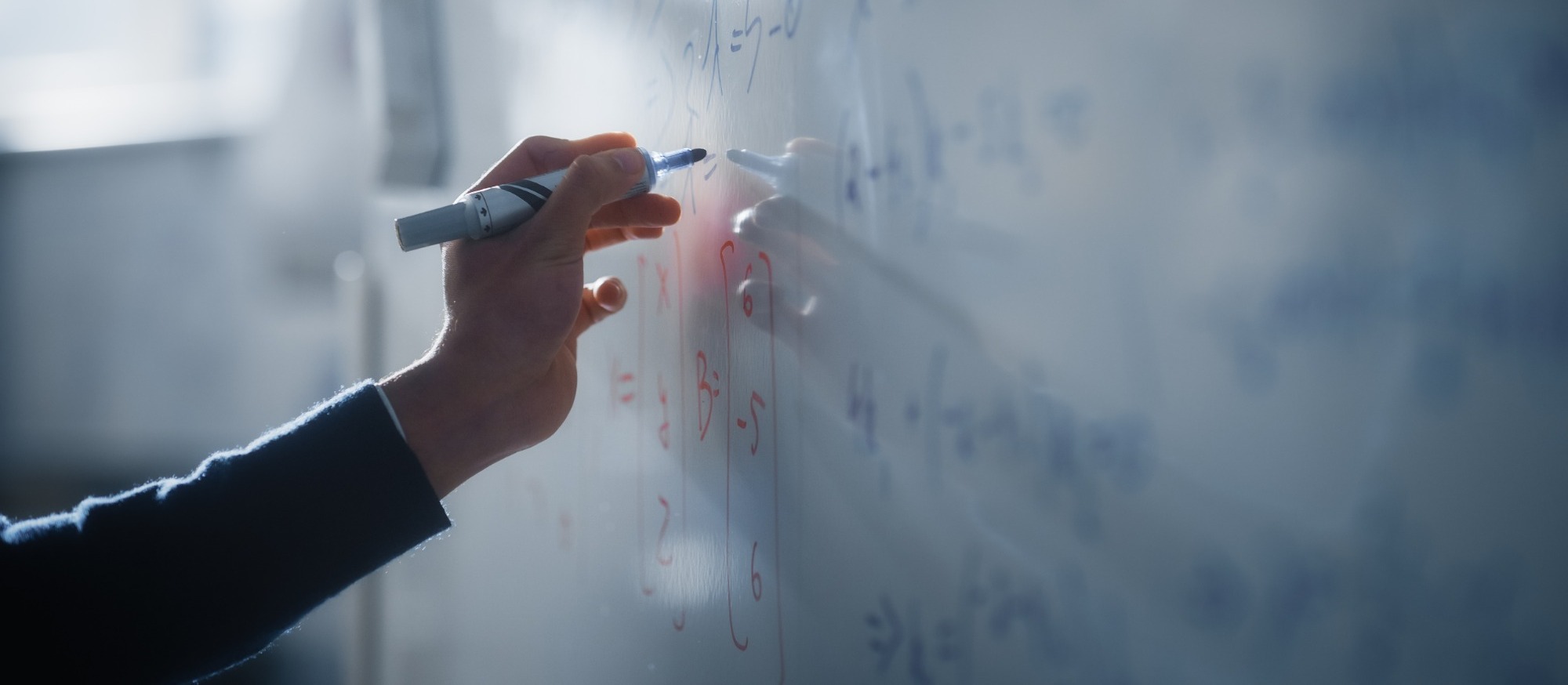 Teacher writing on a White Board