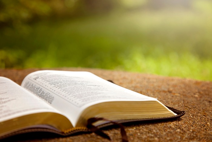 Religious book on on a table outside