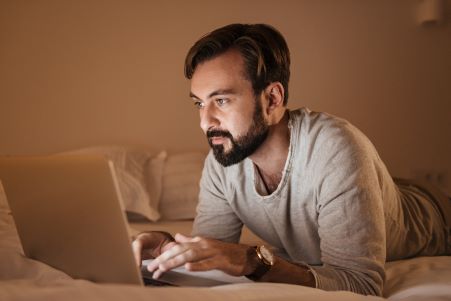 male looking at laptop