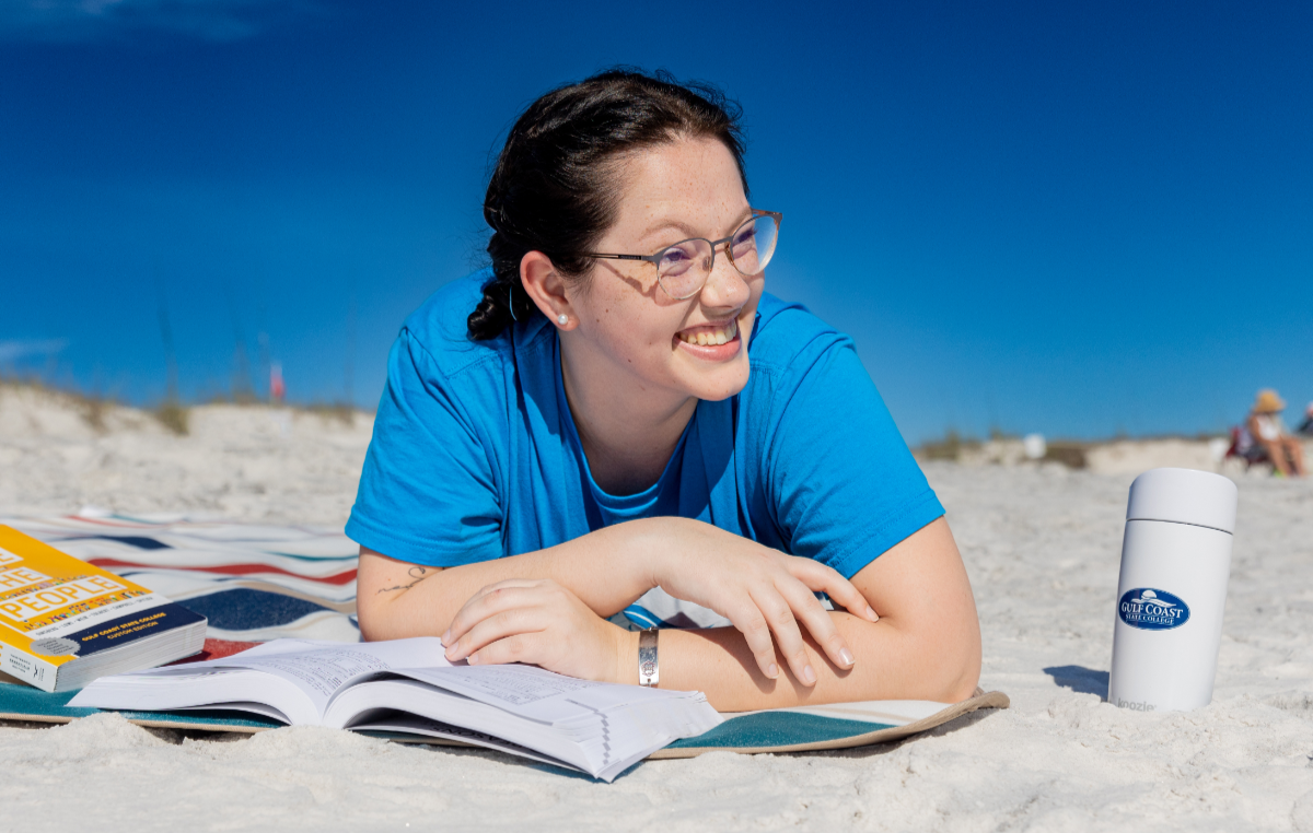 Girl studying on the beach