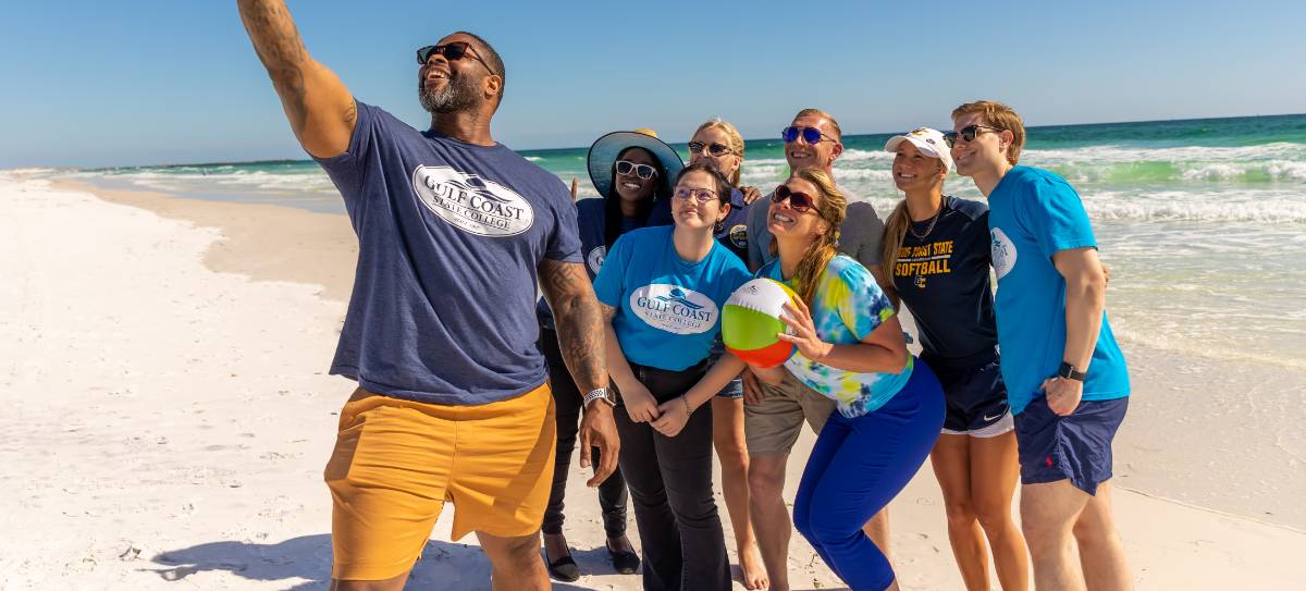 Students on the beach taking a selfie