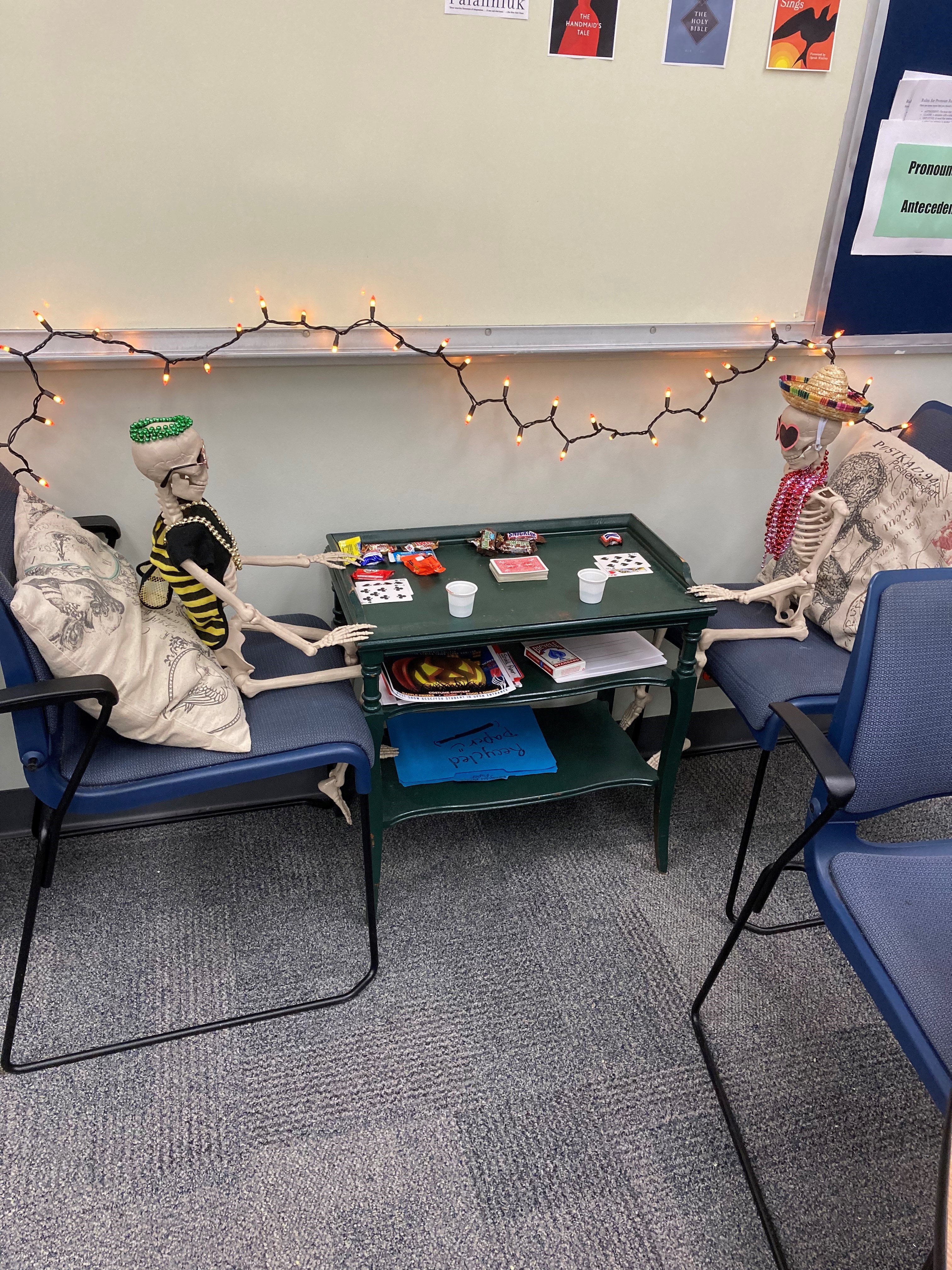 Writing and Reading Lab Halloween Decorations outside the GCSC's Writing and Reading Tutoring Lab. Skeletons playing cards.
