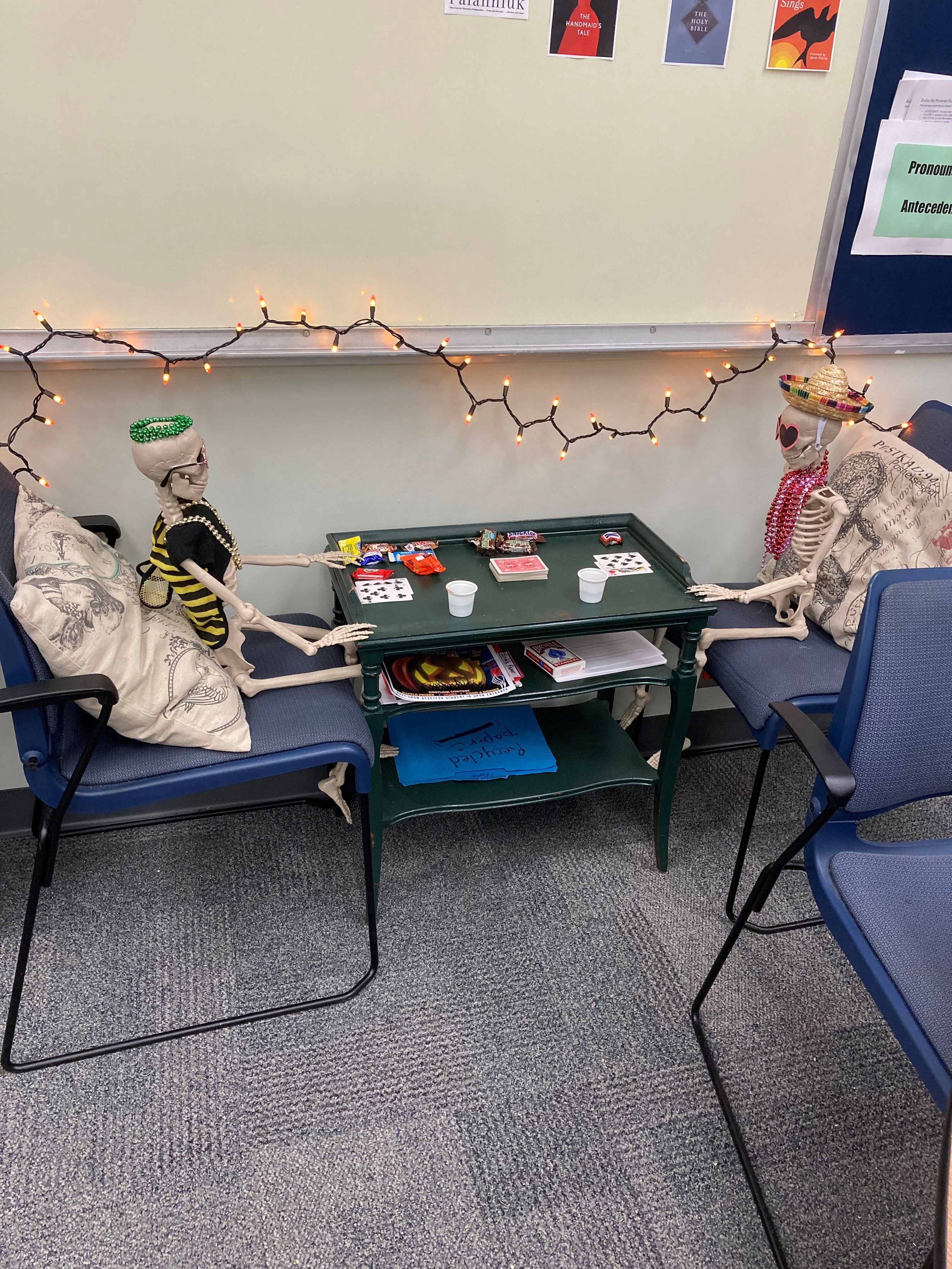 Halloween Decorations outside the GCSC's Writing and Reading Tutoring Lab. Skeletons playing cards.