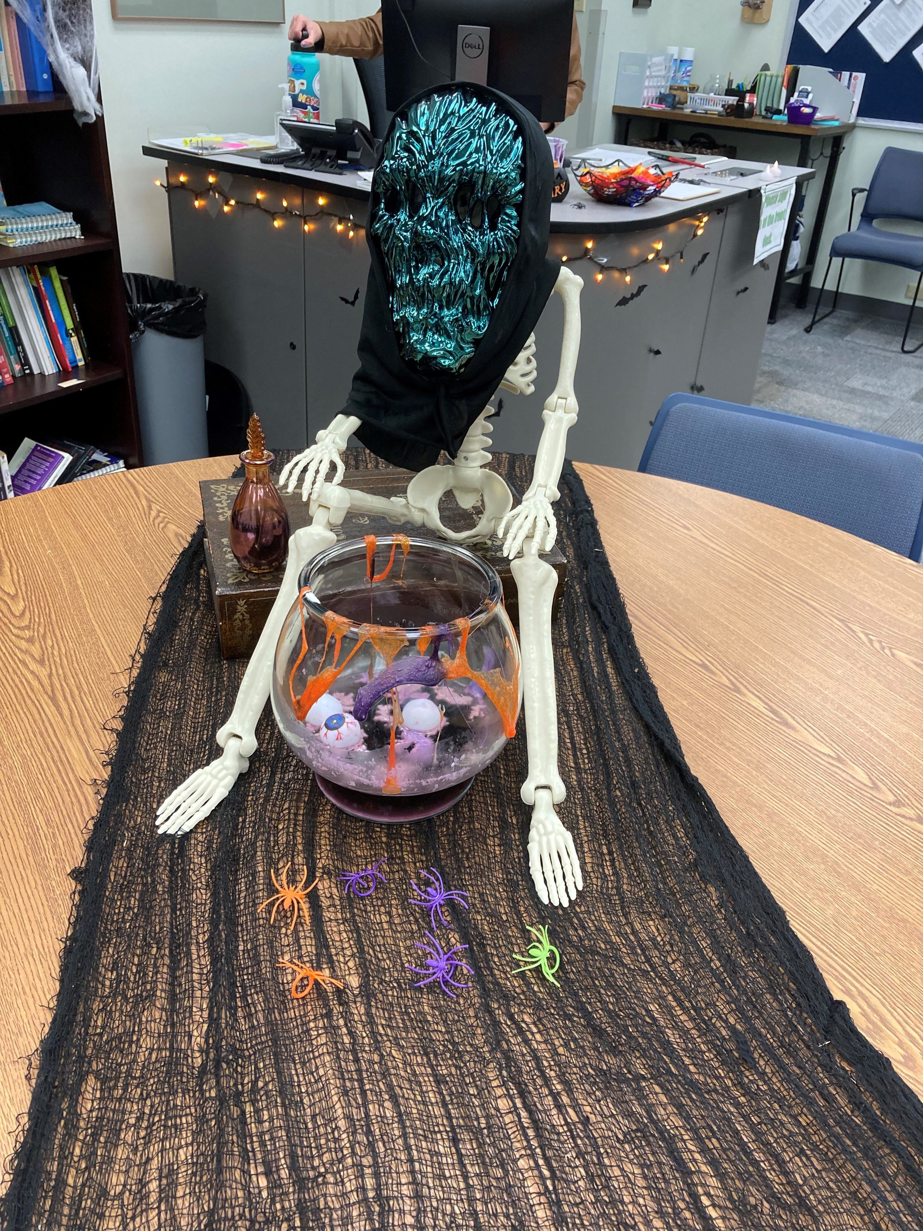Halloween Decorations outside the GCSC's Writing and Reading Tutoring Lab. Skeleton sitting in the candy bowl.