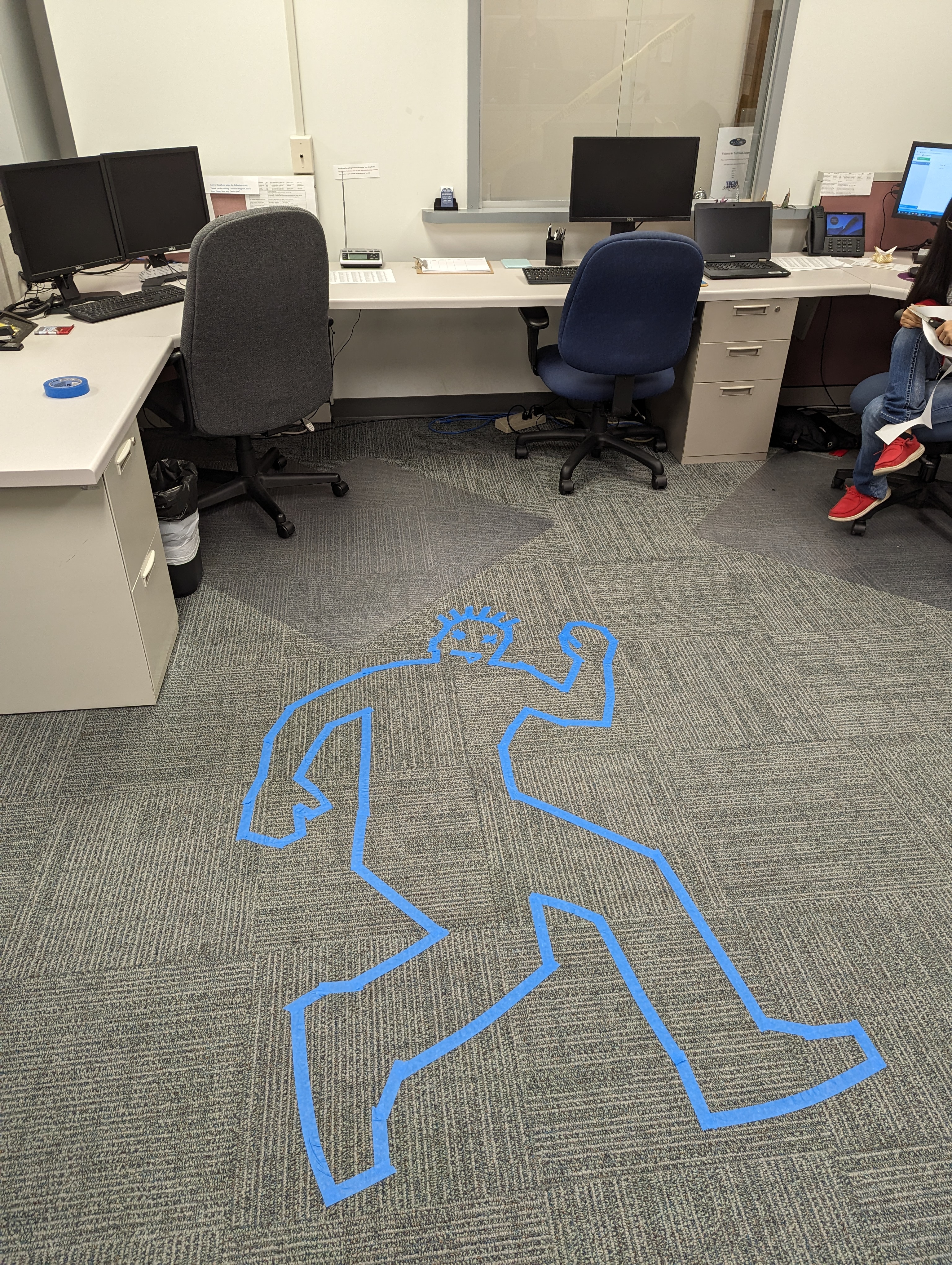 Halloween Decorations in GCSC's ITS Building. Dead body outline at the help desk.