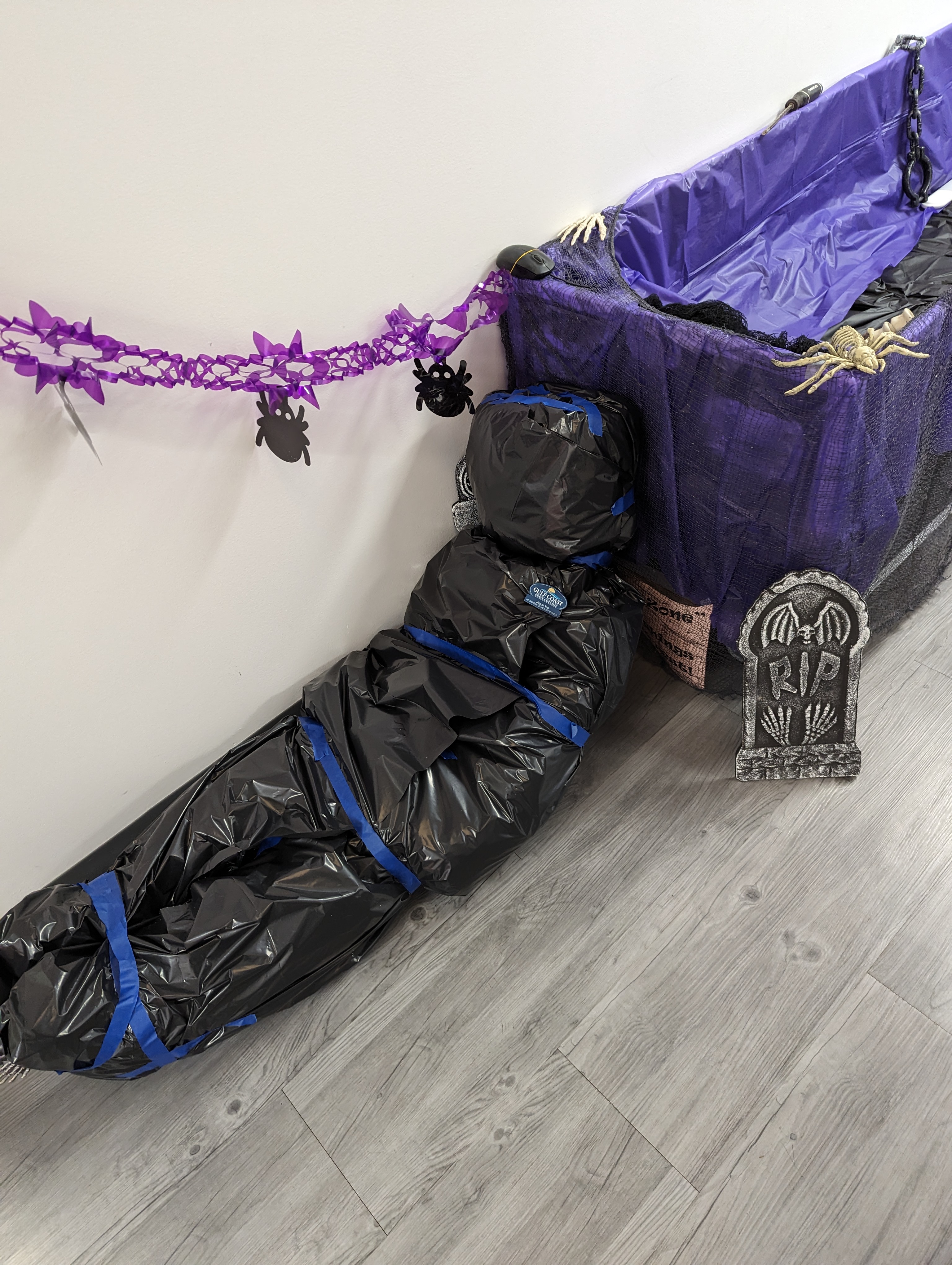 Halloween Decorations in GCSC's ITS Building. Dead body next to a coffin.  