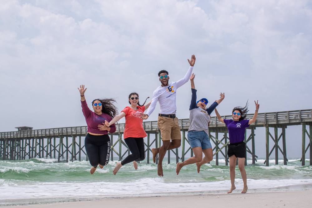 Kids at Beach Jumping in air